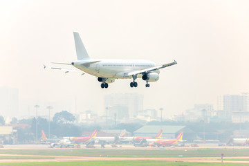 Fototapeta na wymiar Airplane flying over urban areas prepare landing
