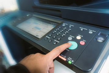 Man touch startup copying paper from Photocopier with access control for scanning in the office business 