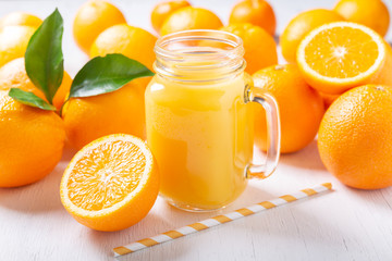 glass jar of fresh orange juice with fresh fruits