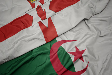 waving colorful flag of algeria and national flag of northern ireland.