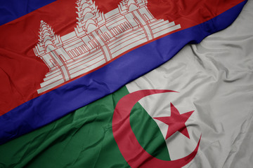 waving colorful flag of algeria and national flag of cambodia.