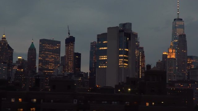 Manhattan at dusk - Moving shot of New York skyscrapers, clip shows depth through multiple planes of buildings passing at different speeds so the viewer gets a sense of how large the city is