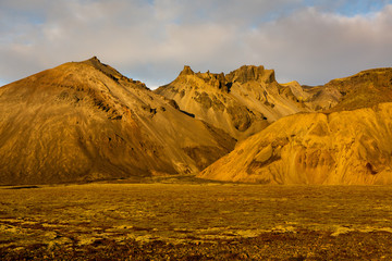 Colorful autumn nature. Travel to Iceland. Beautiful Icelandic landscape with mountains, sky and clouds.