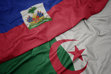 waving colorful flag of algeria and national flag of haiti.