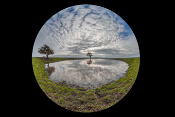 A view of a dew pond on Ditchling Beacon in Sussex, taken with a fish eye lens