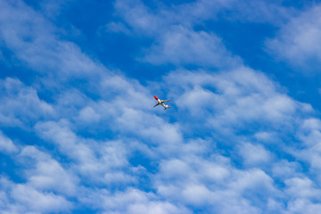Fototapeta na wymiar blue sky with White Clouds and a plane