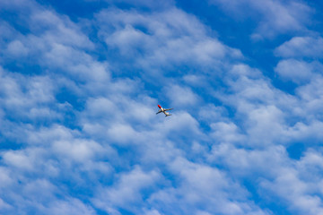 blue sky with White Clouds and a plane