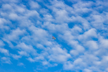 blue sky with White Clouds and a plane