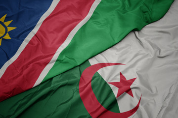 waving colorful flag of algeria and national flag of namibia.