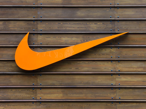 LONDON, UK - CIRCA MAY 2012: Orange Nike logo on a wooden wall at the official Nike store at Westfield Stratford City shopping centre.
