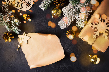 Christmas backdrop flat lay on dark background with gift, ball, fir and cone.