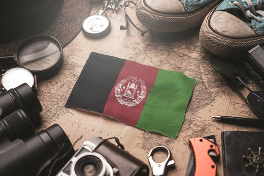 Afghanistan Flag Between Traveler's Accessories on Old Vintage Map. Tourist Destination Concept.