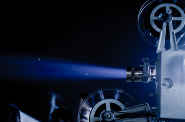 beam light blue color of vintage movie projector in the outdoor street festival