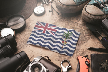 British Indian Ocean Territory Flag Between Traveler's Accessories on Old Vintage Map. Tourist Destination Concept. © natanaelginting
