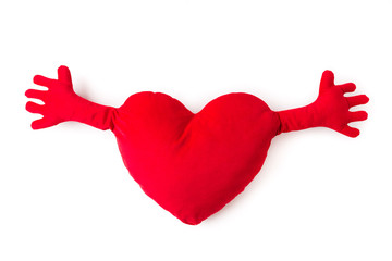 Close-up of red heart pillow with hands isolated