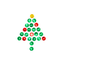 Christmas tree symbol made of red, green and gold glitter sparkles on the left on a white background. Flat lay, top view christmas, new year, winter creative concept.