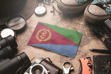 Eritrea Flag Between Traveler's Accessories on Old Vintage Map. Tourist Destination Concept.