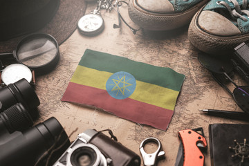 Ethiopia Flag Between Traveler's Accessories on Old Vintage Map. Tourist Destination Concept.