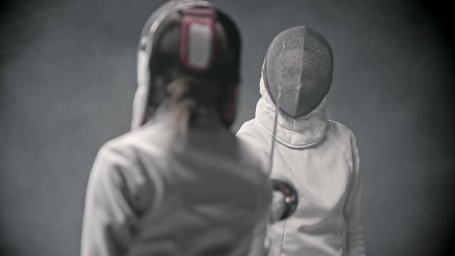 Fencing training - two women greeting each other before the duel