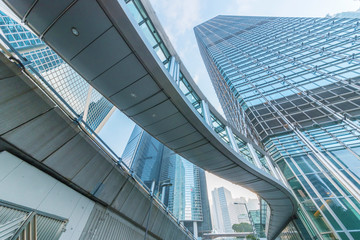 Fototapeta na wymiar Modern office building and pedestrian walkway in Hong Kong city