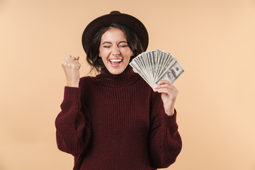 Emotional brunette woman holding money.