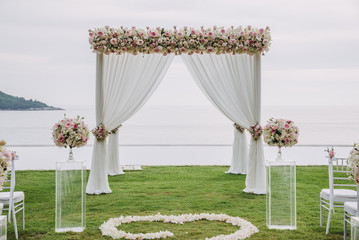 Wedding ceremony. Arch; decorated with flowers. - 303524444
