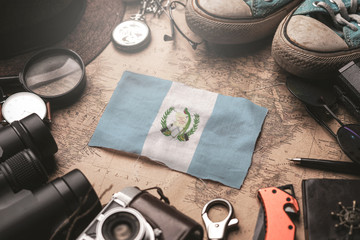Guatemala Flag Between Traveler's Accessories on Old Vintage Map. Tourist Destination Concept.
