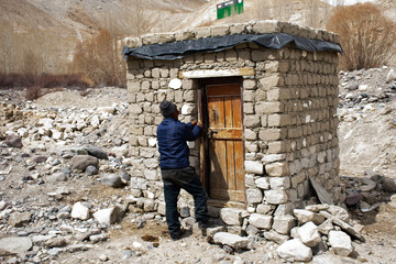 Earthen house and toilet at resting area for travelers people use service on Khardung La Road between journey nubra lake valley go to Leh Ladakh village in Jammu and Kashmir, India