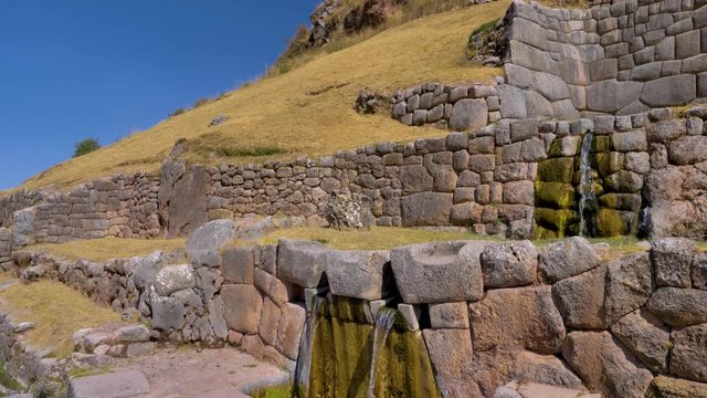 Fountain with different waterfalls. Water falls from the top through different levels. Inca construction at the Tambomachay Archaeological Site in the Cusco region, Peru