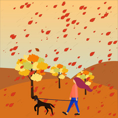 Woman walking with her dog in park in the fall. Dog sitting concept.