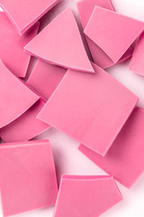Ruby chocolate slices, a close-up overhead shot of a heap on a white background