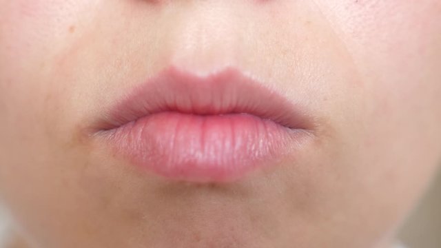 kiss lips Close-up. beautiful smile of young woman. girl smiling teeth and lips close-up.