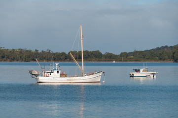 Seascape with white fishing boat and yacht. Summer recreation background