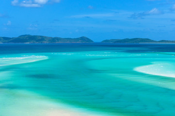 Tropical lagoon with turquoise blue water and mountains on the background