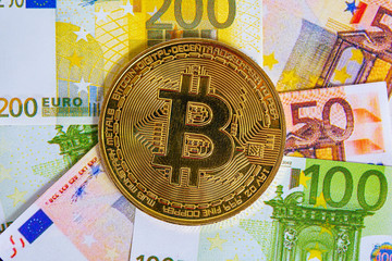 Bitcoin cryptocurrency. Golden bitcoin on euro banknotes background. Bitcoin crypto currency, Blockchain technology, digital money, Mining concept, bitcoin on euro bill.