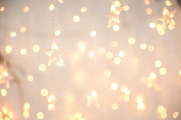 Background of New Year's garlands like stars. Christmas atmosphere with garlands in focus and defocus.