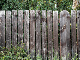 Old low and painted fence on a cloudy day front view