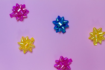 lots of bows on pink background. bows on a colored background. for postcards.Christmas tree decoration. space for text. the view from the top. 2020.