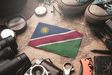Namibia Flag Between Traveler's Accessories on Old Vintage Map. Tourist Destination Concept.