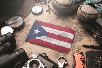 Puerto Rico Flag Between Traveler's Accessories on Old Vintage Map. Tourist Destination Concept.