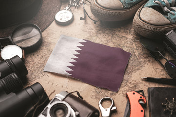 Qatar Flag Between Traveler's Accessories on Old Vintage Map. Tourist Destination Concept.