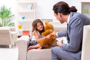 Child psychologist attending small girl