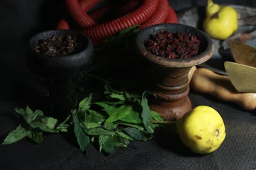 Foto op Plexiglas bowl with tobacco for hookah. fruits on a dark background. smoking nargile © Serhiy