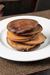 chocolate pancakes on the white plate