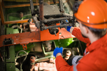 profession of a miner. A young miner in a coal mine in the generals is busy with work, repairing...