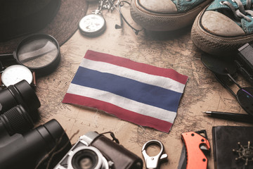 Thailand Flag Between Traveler's Accessories on Old Vintage Map. Tourist Destination Concept.