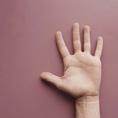 man hand gesturing on the pink wall, pink background