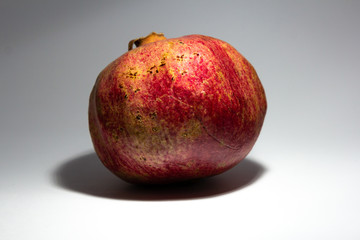 Pomegranate isolated on white background. Sweet and juicy garnet with copy space for text. Garnets isolated on white.