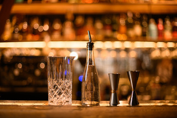 Measuring glass cup, bottle with a pourer and jiggers