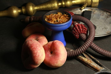 bowl with tobacco for hookah. fruits on a dark background. smoking shisha